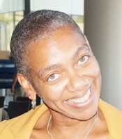 Headshot of Rhonda Williams, a middle aged black woman with close cropped graying hair. She is wearing a gold top and smiling brightly.