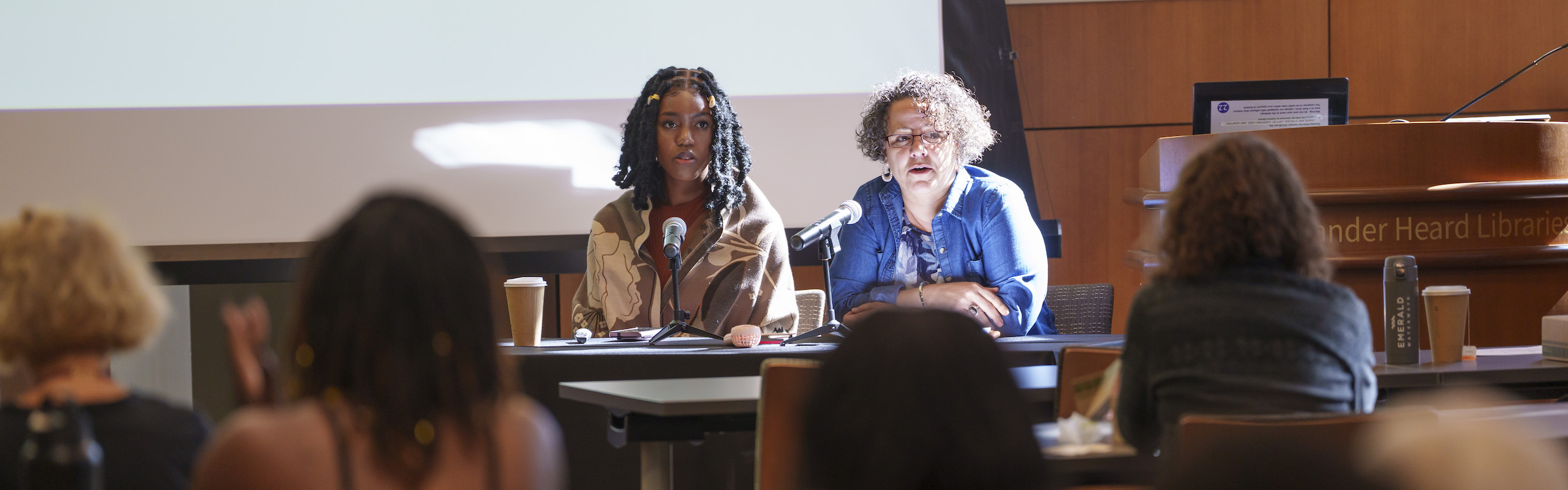 Two women speaking to a group