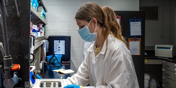 photo of student in facemask working in the lab