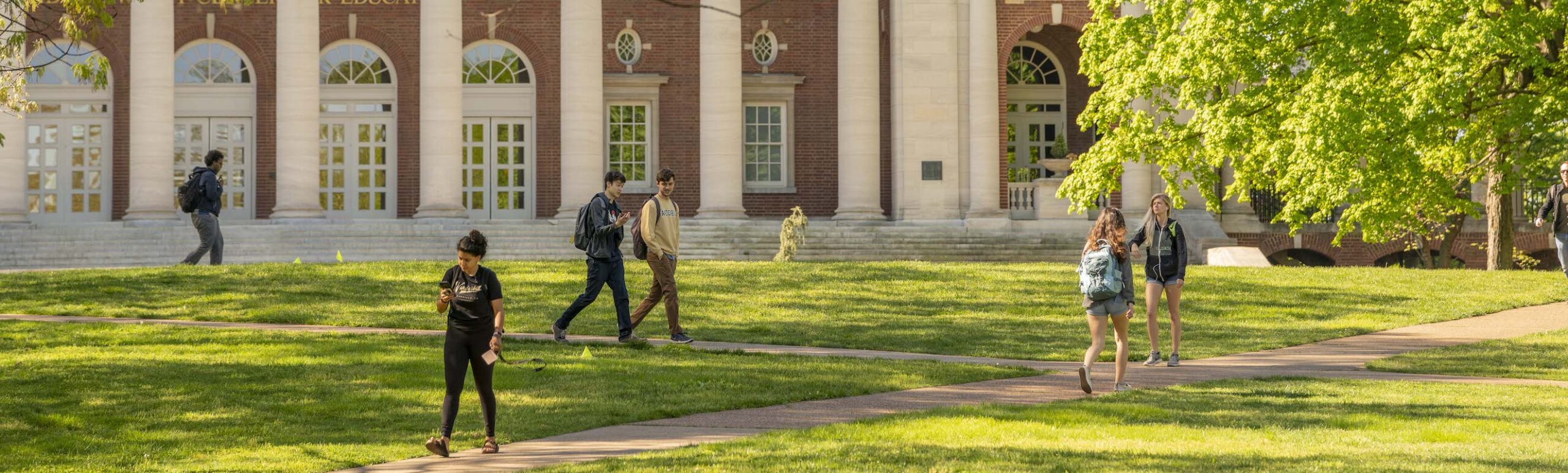 students walking around campus on sunny day