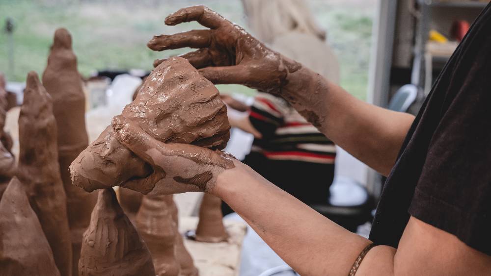 hands making a clay sculpture