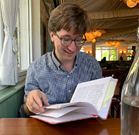 man looking at book