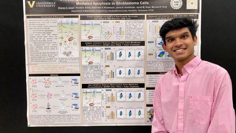 Shanay Desai in front of conference poster
