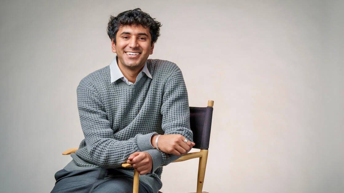 Vivek Kumar sitting in a chair, smiling