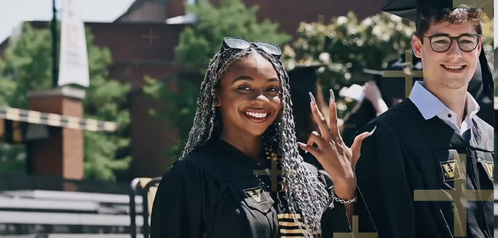 graduate smiling and doing 'Dores hang symbol