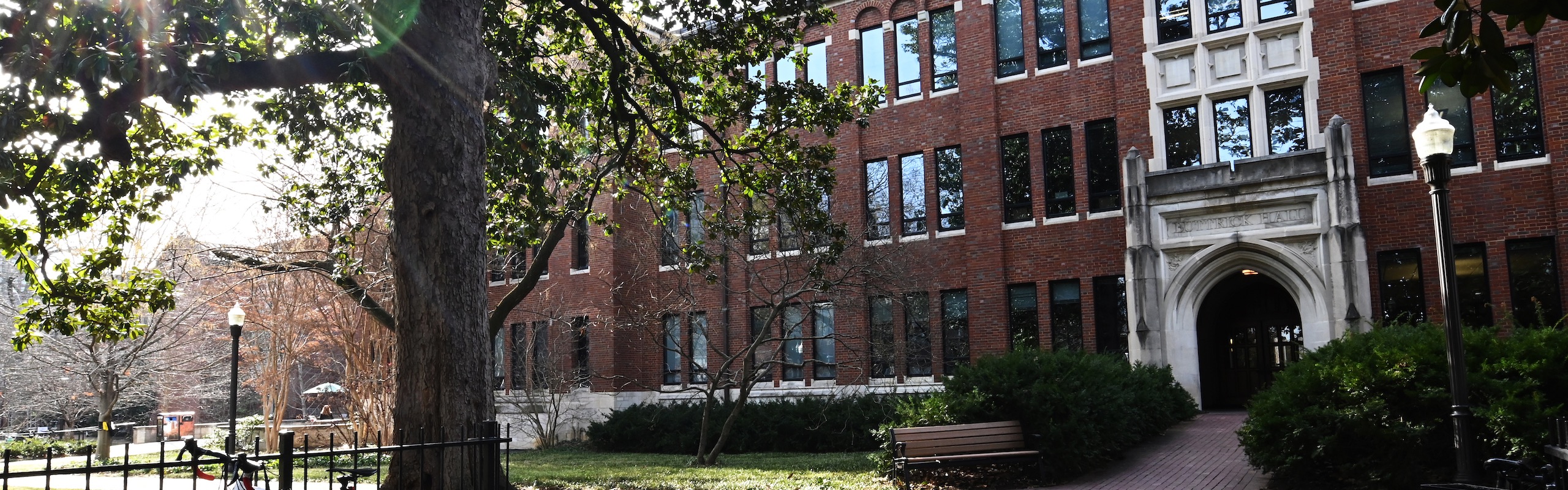 Exterior shot of Buttrick Hall through the trees