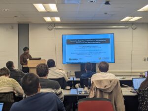 Umar Sohail Qureshi, a senior triple majoring in physics, mathematics, presenting his research.