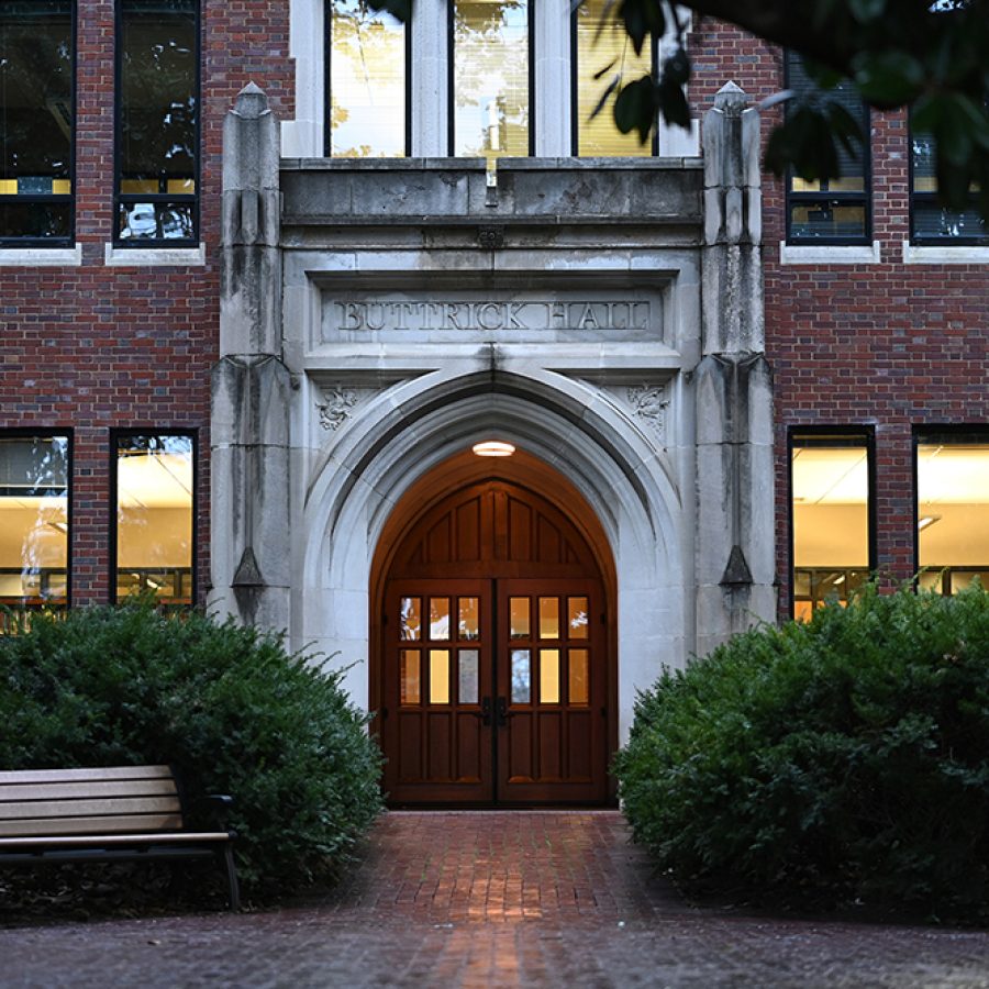 An exterior shot of a building with an arched door.
