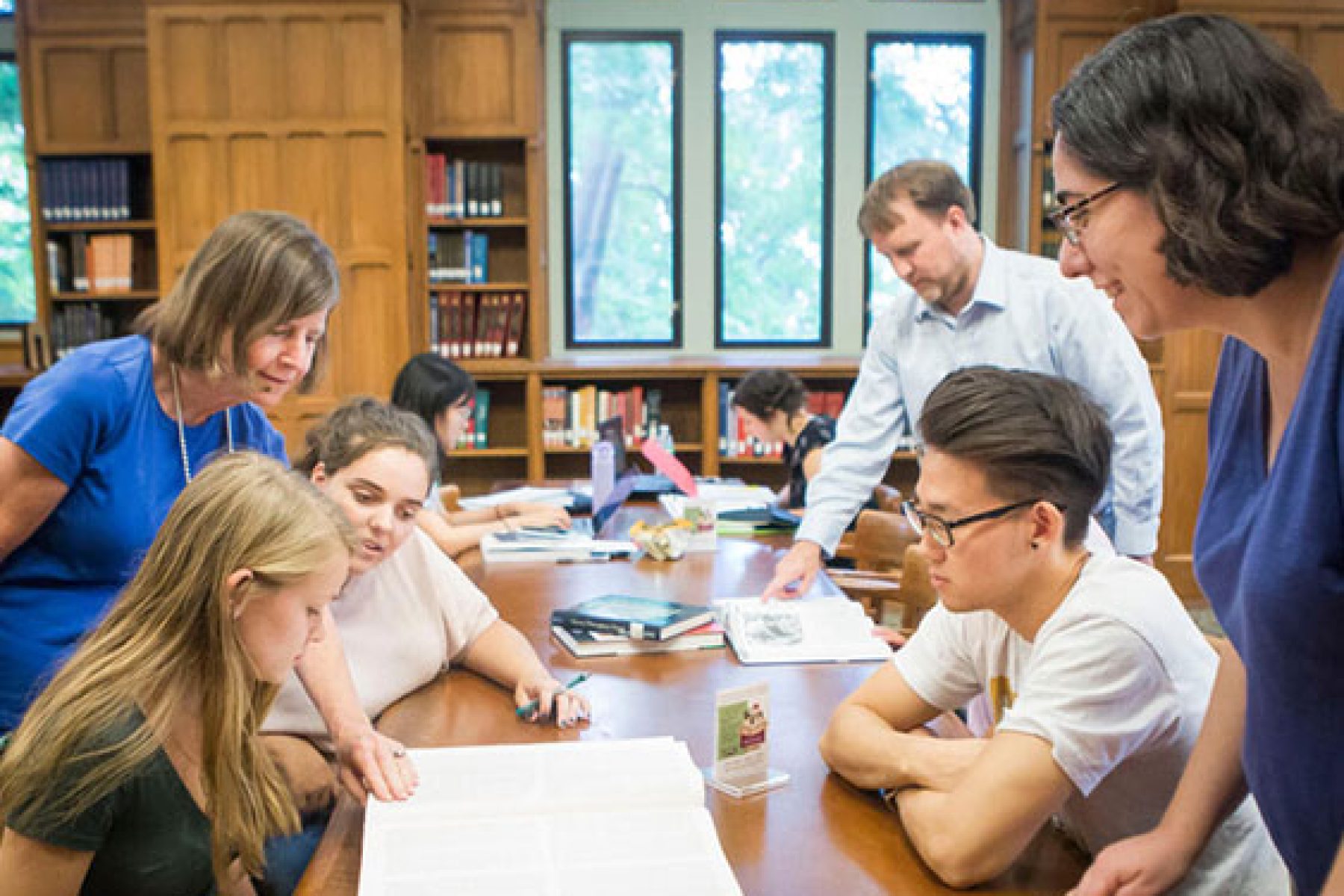A group of students sit around a table